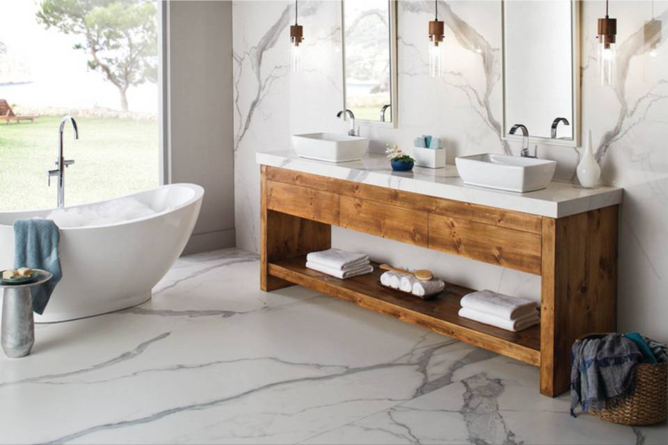 marble look stone tile in bathroom with bathtub and vanity.